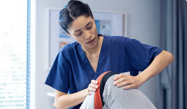 physiotherapist treating a patient's knee