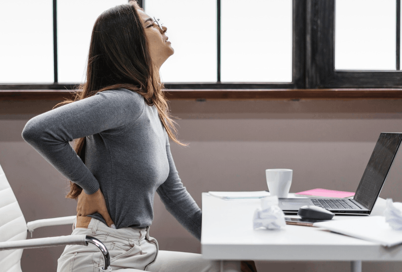 woman with back pain from prolonged sitting