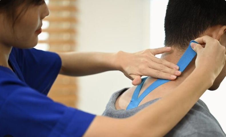 physiotherapist applying kinesiology tape on the patient's neck