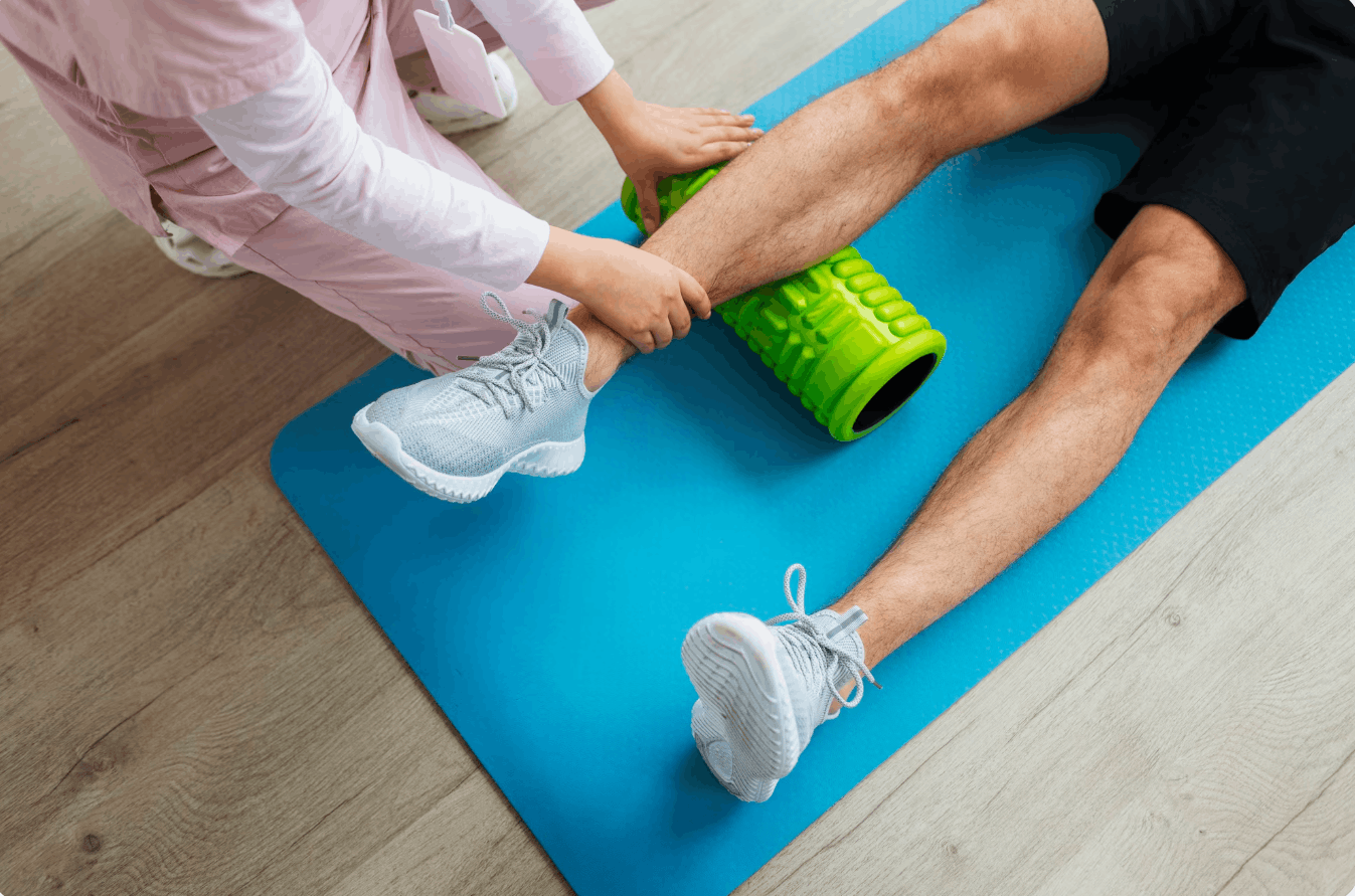 physiotherapist rolling a patients calf on a rolling foam