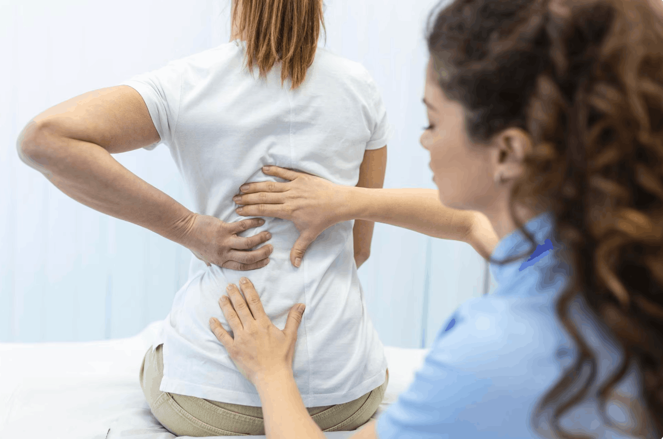 physiotherapist examining the patient's back