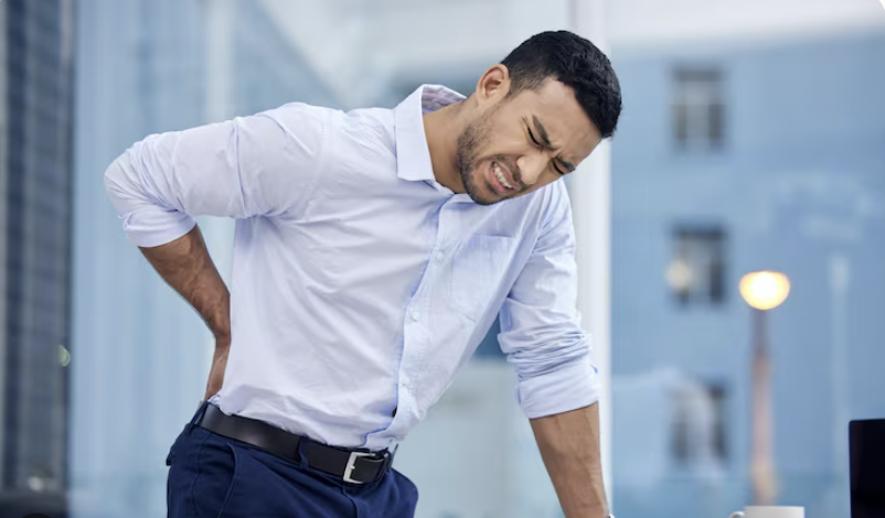 guy with lower back pain with a painful expression