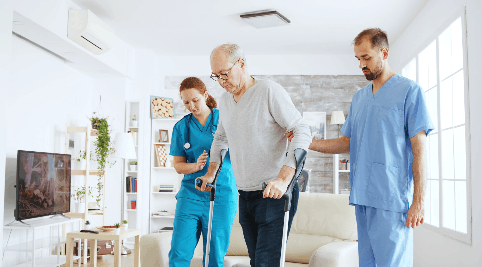 two physiologists helping an elderly patient walk