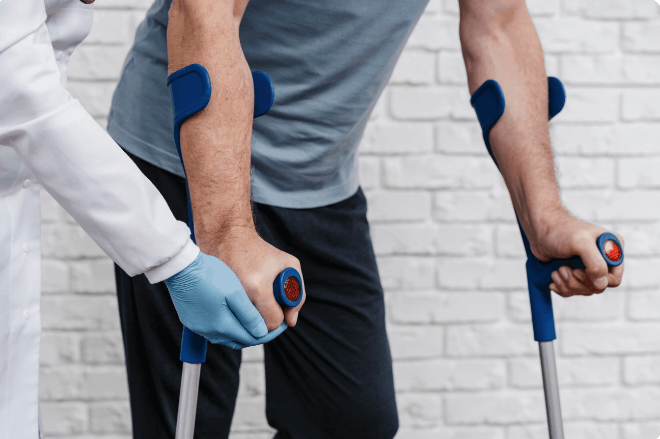 patient with crutches and a doctor guiding