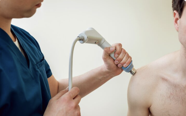 physiotherapist performing shockwave therapy